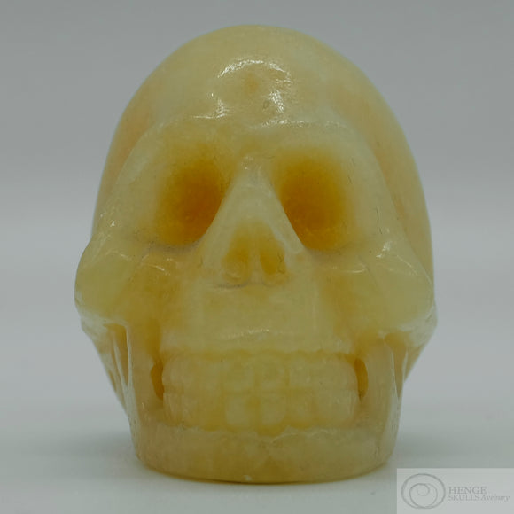 Orange Calcite Human Skull