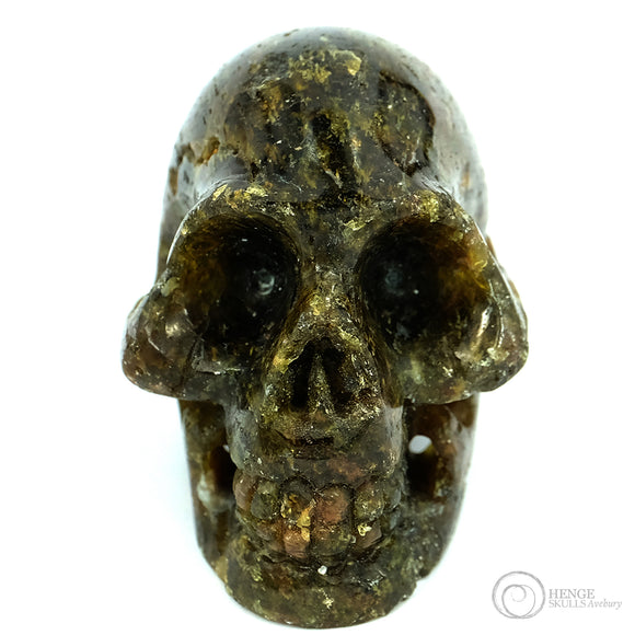 Green and brown small human skull
