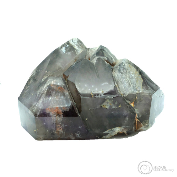 Large faceted brown and grey quartz with purple colourings in the bottom of the stone